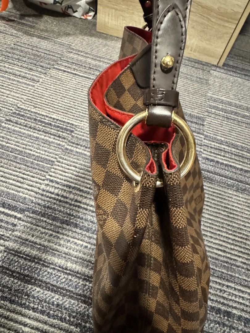 graceful Louis Vuitton Damier Ebene Berkeley Handbag (Category: Luxury Bags & Wallets) located in Calamba. Submitted by im.fineee (Listing ID 1465974763, Image 3). Description: - Brand: Louis Vuitton - Style: Classic hobo shoulder bag - Material: Damier Ebene canvas with dark brown leather trim - Hardware: Gold-tone - Interior: Spacious red lining - Details: Front leather patch stamped with Louis Vuitton Paris - Condition: Excellent daily use bag