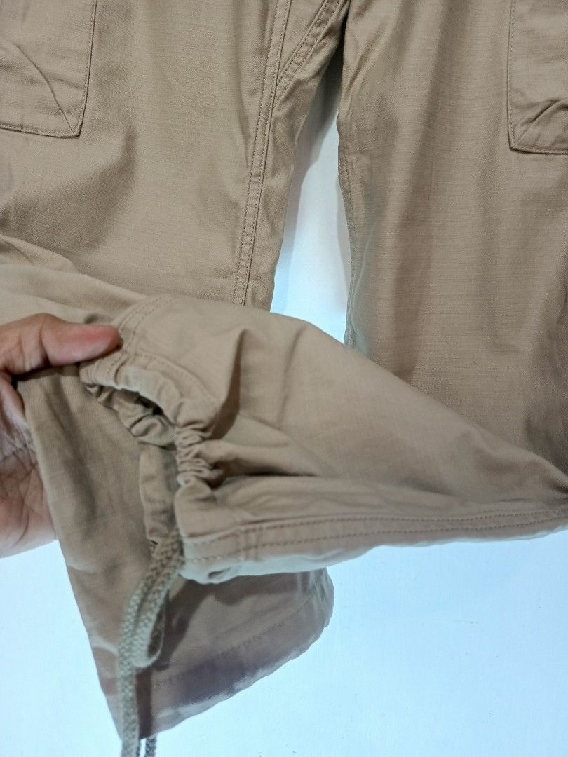 GRAMICCI KHAKI CARGO PANTS (Category: Trousers) located in Baguio. Submitted by 074thriftmania (Listing ID 1466119192, Image 2). Description: - Brand: Gramicci - Item: Cargo Pants - Color: Khaki - Material: 100% Cotton (Made in China) - Size: Asia M / US & EU S - Built-in nylon webbing belt with integrated buckle - Comfortable elastic waistband - Practical multiple side cargo pockets - Adjustable drawstring cuffs at the ankles - Perfect for daily