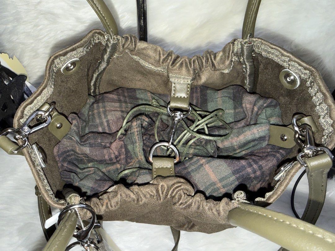 Green MERCH Crossbody Bag with Pouch (Category: Cross-body Bags) located in Taguig. Submitted by roseanneramirez (Listing ID 1466026258, Image 3). Description: - Brand new with tags attached - Trendy olive green design with chunky 'MERCH' lettering - Dual top handles and a detachable, adjustable shoulder strap - Multiple interior compartments for easy organization - Includes a matching plaid drawstring inner pouch - Comes with a stylish patterned