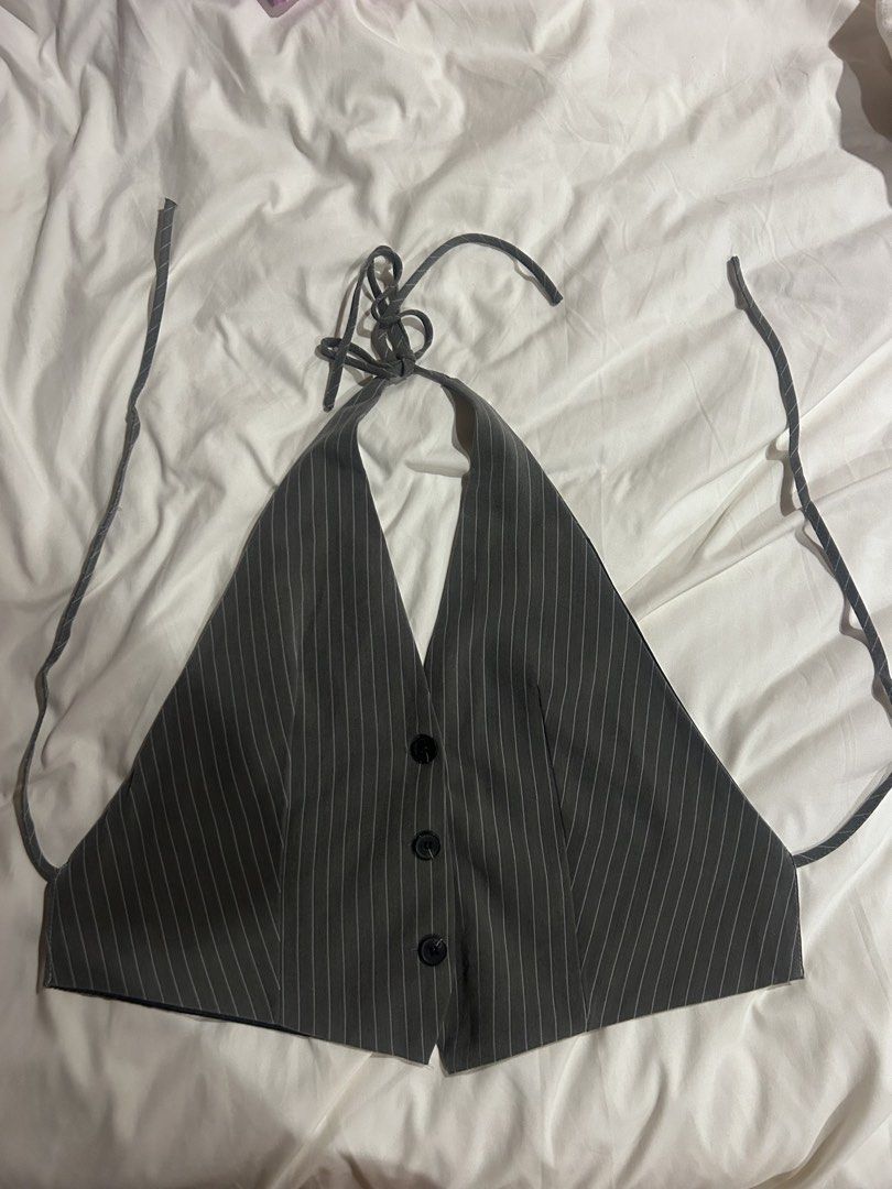 Grey Pinstripe Halter Backless Vest Top (Category: Sleeveless) located in Cebu City. Submitted by shopmikascloset (Listing ID 1466057132, Image 2). Description: XS to M - Style: Grey halter top with white pinstripes and vest-style front - Details: Three black buttons, adjustable neck and back tie straps - Fit: Cropped length, looks great with high-waisted pants or skirts - Condition: Clean, EUC with no flaws found.