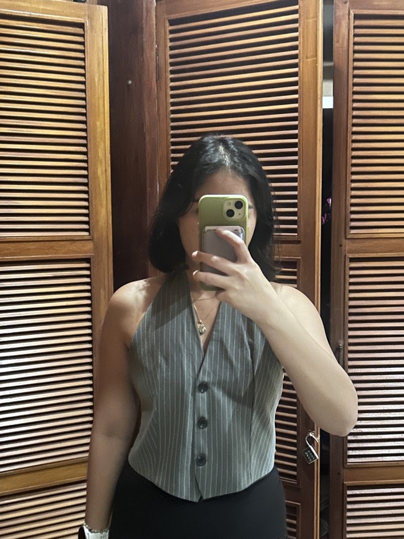 Grey Pinstripe Halter Backless Vest Top (Category: Sleeveless) located in Cebu City. Submitted by shopmikascloset (Listing ID 1466057132, Image 1). Description: XS to M - Style: Grey halter top with white pinstripes and vest-style front - Details: Three black buttons, adjustable neck and back tie straps - Fit: Cropped length, looks great with high-waisted pants or skirts - Condition: Clean, EUC with no flaws found.