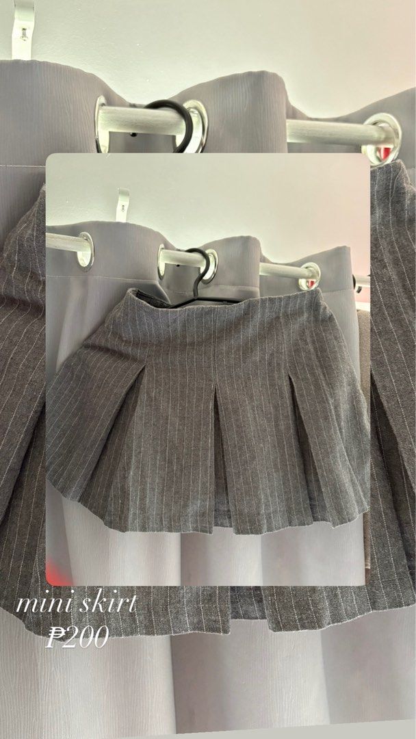 Grey Pinstripe Pleated Mini Skirt (Category: Skirts) located in Makati City. Submitted by jrnhnnh3047116 (Listing ID 1466026608, Image 1). Description: - Color: Grey with white pinstripes - Style: Pleated tennis skirt design - Fit: Fitted waistband with structured pleats - Styling: Great to pair with basic tees or sweaters - Price: Only P200.