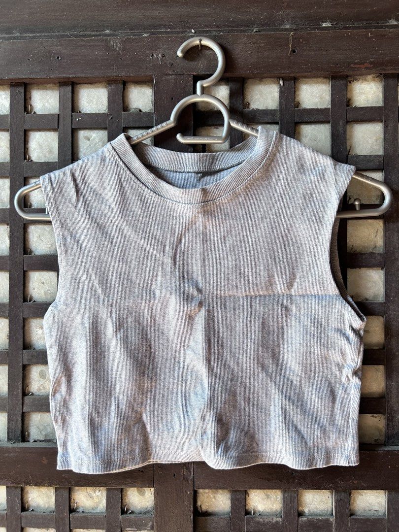 Grey ribbed crop top sleeveless basic (Category: Sleeveless) located in Makati City. Submitted by hzsans92 (Listing ID 1466103638, Image 1). Description: - Color: Grey - Style: Sleeveless crop top with classic round neckline and fitted cut - Fabric: Soft, stretchy ribbed knit material - Versatility: Easy to match with high-waisted jeans or skirts - Condition: Worn a few times, solid shape, clean and ready to wear.
