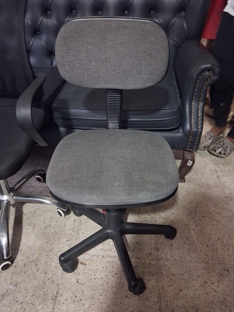 Grey rolling task chair with casters and backrest (Category: Office Furniture & Fixtures) located in Taguig. Submitted by ssvcn (Listing ID 1466067121, Image 1). Description: - Color: Textured grey fabric - Mobility: Swivel base with sturdy black casters for easy movement - Comfort: Cushioned seat and back pad for all-day support - Functionality: Smooth working height adjustment mechanism - Ideal for: Home offices, study rooms, or compact spaces 