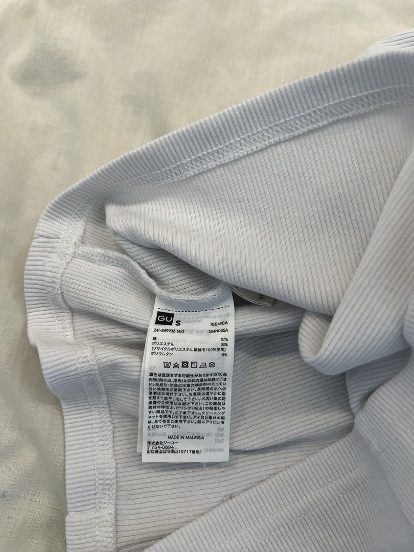 GU Ribbed Square Neck Top White Size S (Category: Sleeveless) located in Quezon City. Submitted by pattyyspreloved (Listing ID 1465965420, Image 2). Description: - Brand: GU - Size: S (Made in Malaysia) - Color: White - Material: Soft, stretch knit fabric - Design: Square neckline, short sleeves with shoulder straps, front button-down closure - Condition: Clean, tags intact inside.