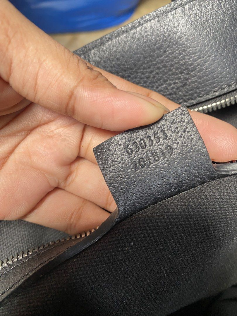 Gucci Black GG Canvas Tote Bag (Category: Luxury Bags & Wallets) located in Manila. Submitted by gentlegem.3c778e (Listing ID 1466069068, Image 3). Description: - Brand: Gucci - Material: Black canvas with classic GG monogram pattern - Accents: Leather handles, circular Gucci logo patch, and silver-tone hardware - Closure & Interior: Secure zip closure, interior clip, and spacious black fabric-lined interior with stamped serial number - Condition