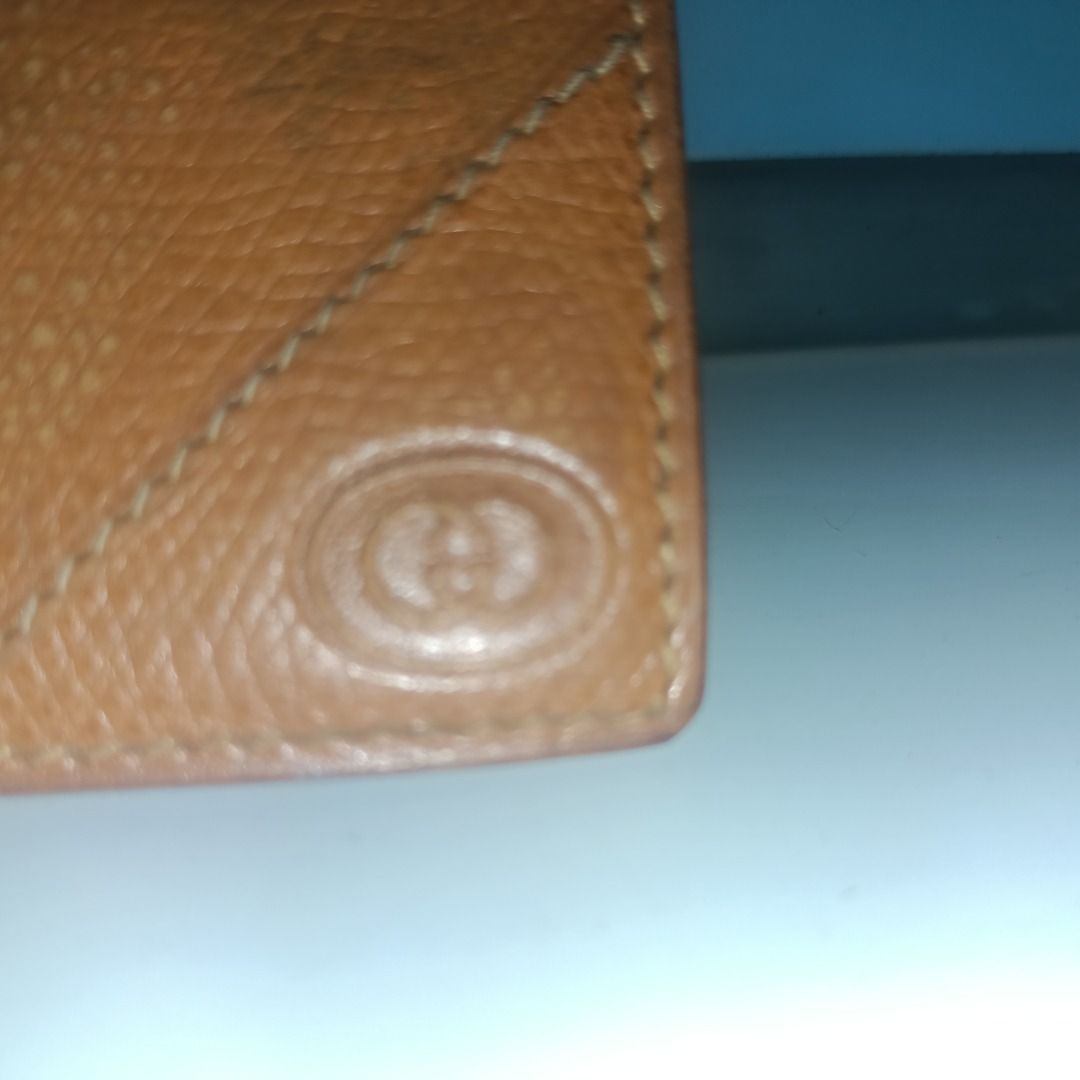 Gucci Brown Leather Bifold Wallet (Category: Luxury Bags & Wallets) located in Munoz. Submitted by larryc1212 (Listing ID 1466114602, Image 3). Description: - Authentic brown Gucci bifold wallet in textured leather - Features iconic embossed interlocking GG logo on the exterior - Interior includes multiple card slots, currency compartments, and a gold-tone Gucci metal plaque - Classic compact design, perfect for everyday carry - Condition: Shows 