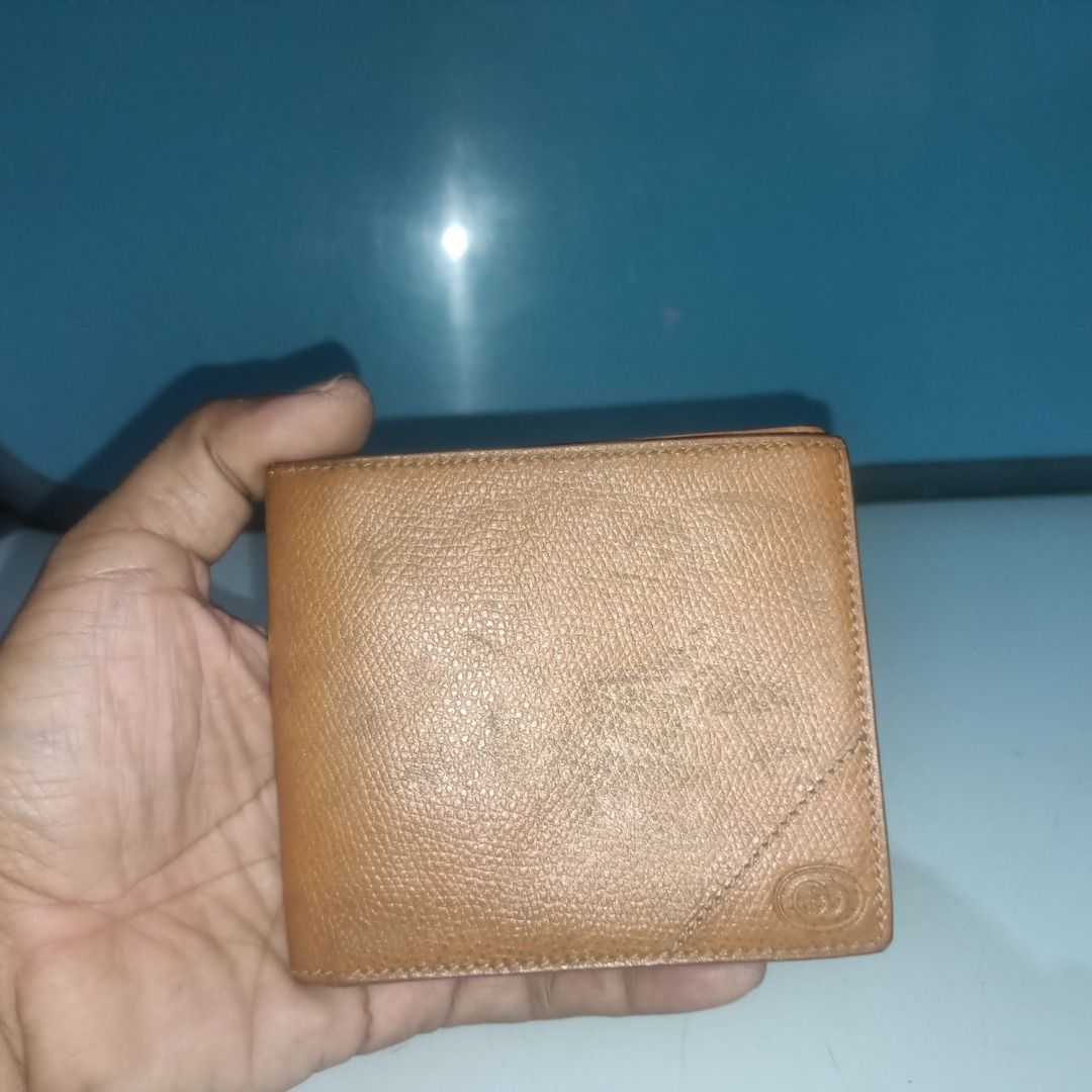Gucci Brown Leather Bifold Wallet (Category: Luxury Bags & Wallets) located in Munoz. Submitted by larryc1212 (Listing ID 1466114602, Image 1). Description: - Authentic brown Gucci bifold wallet in textured leather - Features iconic embossed interlocking GG logo on the exterior - Interior includes multiple card slots, currency compartments, and a gold-tone Gucci metal plaque - Classic compact design, perfect for everyday carry - Condition: Shows 
