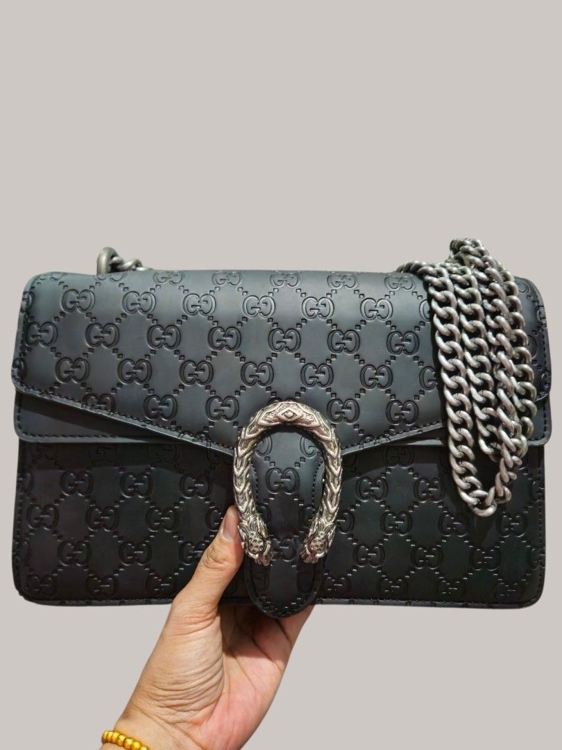 Gucci Embossed Shoulder Bag (Category: Shoulder Bags) located in Caloocan City. Submitted by zoetormojal.18d615 (Listing ID 1466024267, Image 1). Description: Black Gucci Shoulder Bag - Iconic all-over GG embossed pattern - Signature Dionysus tiger head closure - Elegant gun metal hardware - Genuine leather - Timeless design - Versatile shoulder bag or crossbody - Suitable for day or night use - Spacious compartments - Inner zip and pockets - H 7