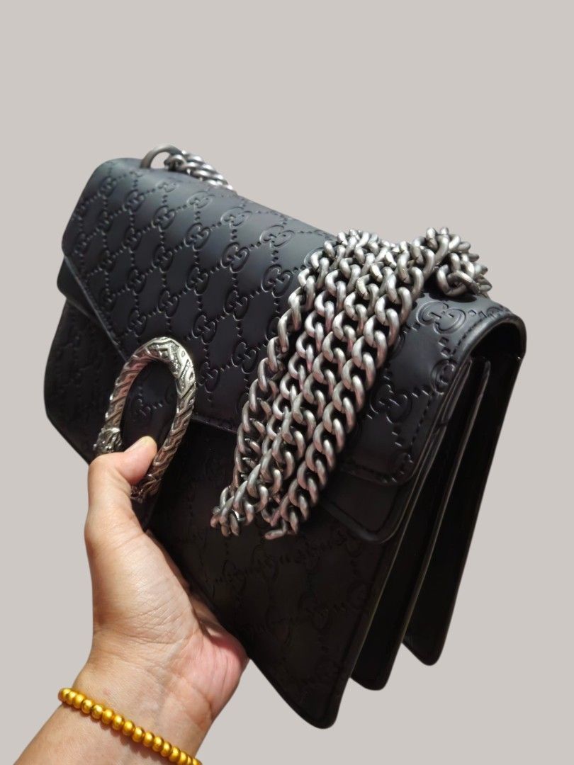 Gucci Embossed Shoulder Bag (Category: Shoulder Bags) located in Caloocan City. Submitted by zoetormojal.18d615 (Listing ID 1466024267, Image 3). Description: Black Gucci Shoulder Bag - Iconic all-over GG embossed pattern - Signature Dionysus tiger head closure - Elegant gun metal hardware - Genuine leather - Timeless design - Versatile shoulder bag or crossbody - Suitable for day or night use - Spacious compartments - Inner zip and pockets - H 7