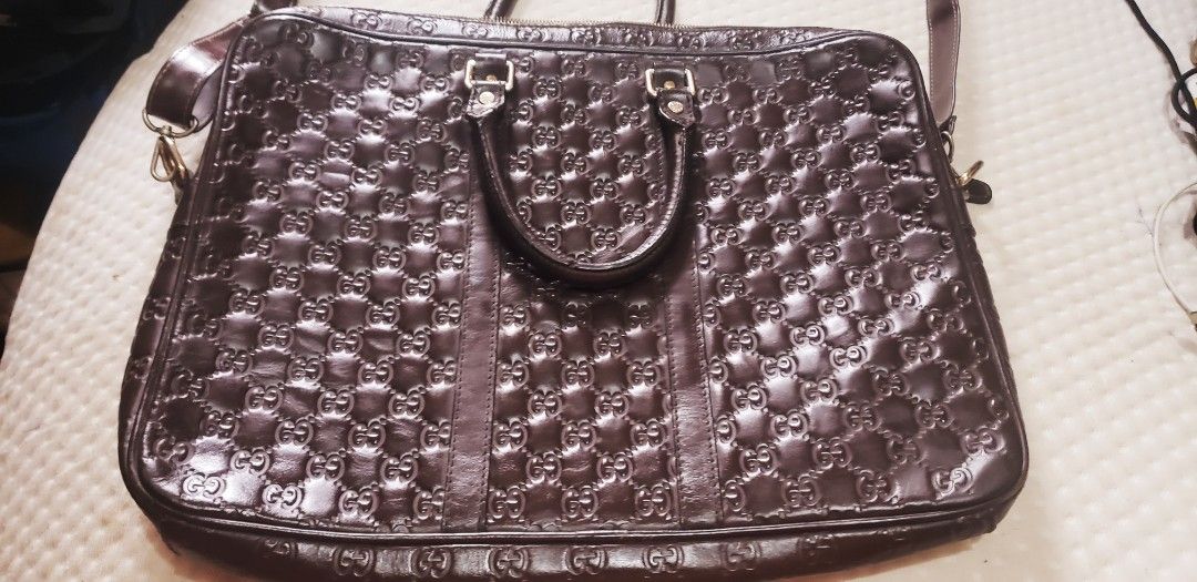 Gucci GG Guccissima Leather Briefcase Brown (Category: Luxury Bags & Wallets) located in Marikina City. Submitted by racoon143 (Listing ID 1465996499, Image 1). Description: - Authentic Gucci briefcase in dark brown Guccissima embossed leather - Classic interlocking G monogram pattern throughout - Secure double top handles and an adjustable/detachable matching shoulder strap - Elegant gold-tone hardware with engraved studs and zippers - Spacious 