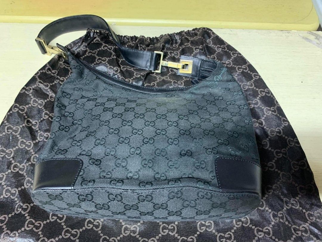 Gucci Monogram Black Canvas Hobo Bag (Category: Luxury Bags & Wallets) located in Gapan. Submitted by cleverstar.36492b (Listing ID 1465994948, Image 2). Description: Black Gucci monogram canvas hobo bag. Leather trim and strap with gold-tone hardware. Includes dust bag. Zip top closure. Clean inside and out. Timeless vintage piece..