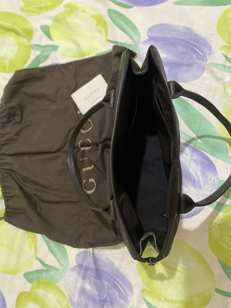 Gucci Monogram Tote Bag Brown (Category: Luxury Bags & Wallets) located in Paranaque City. Submitted by chelleann12 (Listing ID 1466091244, Image 2). Description: - Authentic Gucci dark brown monogram canvas tote - Features iconic web stripe on handles and premium leather trim - Secure top zipper closure - Clean dark brown fabric interior with zipper and slip pockets - Includes original dust bag and authenticity card - Excellent, clean condition 
