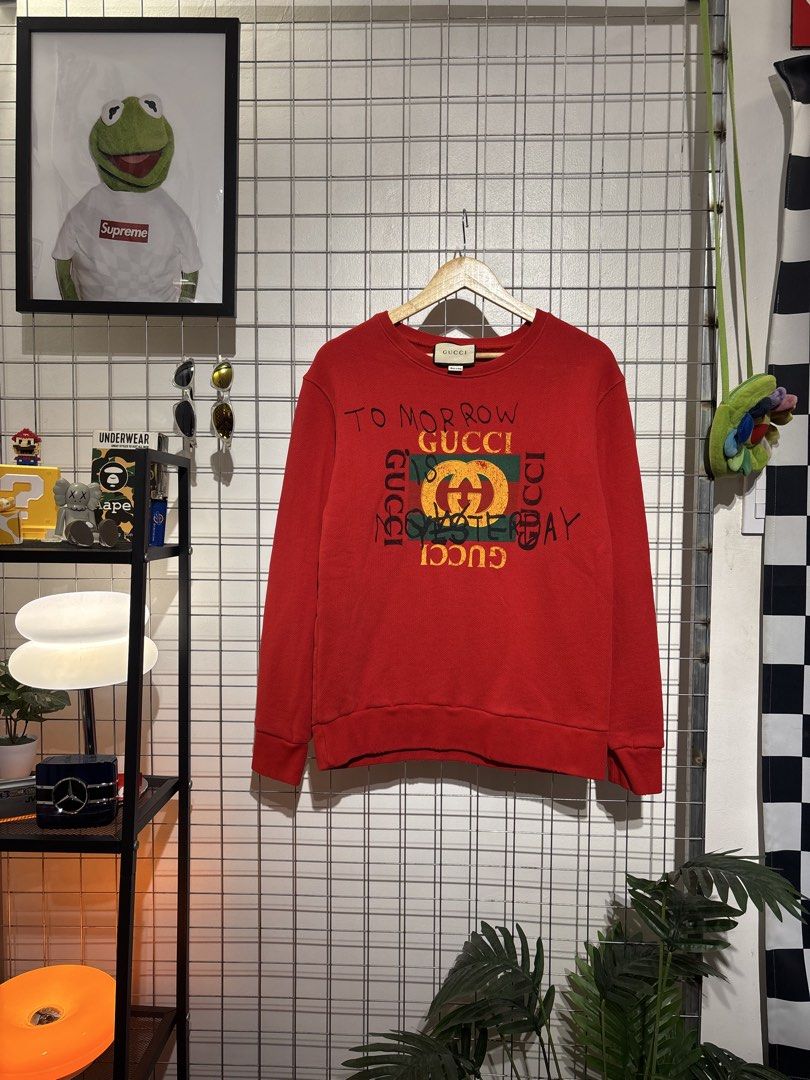 Gucci 'Tomorrow is Yesterday' Red Sweatshirt (Category: Coats, Jackets and Outerwear) located in Cavite. Submitted by vlblgrmnts_ (Listing ID 1466067454, Image 1). Description: Gucci - P-269 20x26 Bestfit Large 9/10 CR 900 - Authentic Gucci red sweatshirt - Features distressed graphics and handwritten 'To morrow Gucci is yesterday' text - Iconic green and red web logo patch on the front - Classic crewneck with ribbed cuffs and hem - Regular fit d