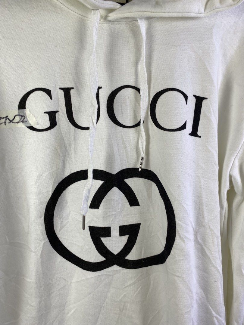 Gucci White Interlocking G Hoodie XL (Category: Coats, Jackets and Outerwear) located in Manila. Submitted by declutterpromax (Listing ID 1466019134, Image 3). Description: - Authentic Gucci hoodie in classic white - Size XL with interior brand and care tags attached - Features the iconic interlocking G logo printed on the chest - Equipped with a comfortable drawstring hood and ribbed cuffs - Premium quality, made in Italy - Condition: Brand new 