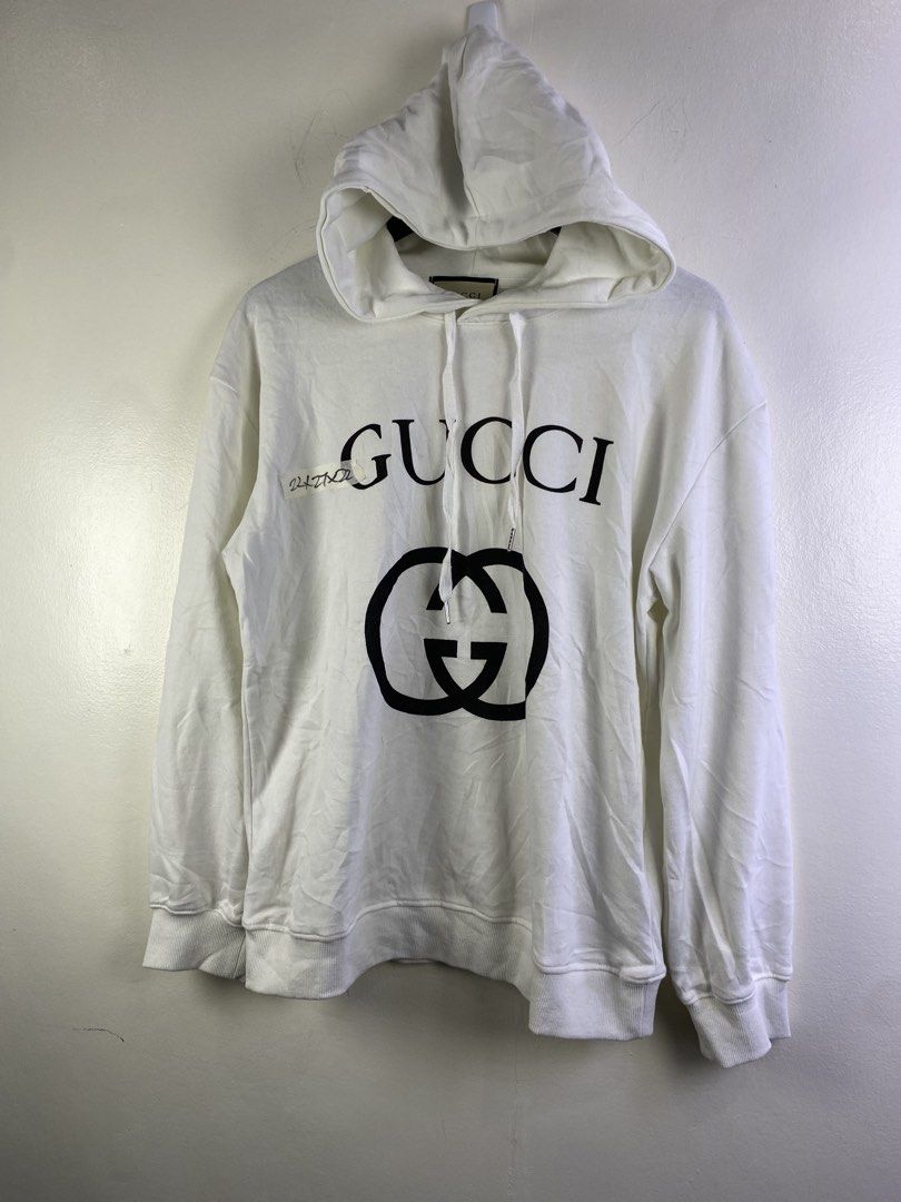 Gucci White Interlocking G Hoodie XL (Category: Coats, Jackets and Outerwear) located in Manila. Submitted by declutterpromax (Listing ID 1466019134, Image 1). Description: - Authentic Gucci hoodie in classic white - Size XL with interior brand and care tags attached - Features the iconic interlocking G logo printed on the chest - Equipped with a comfortable drawstring hood and ribbed cuffs - Premium quality, made in Italy - Condition: Brand new 