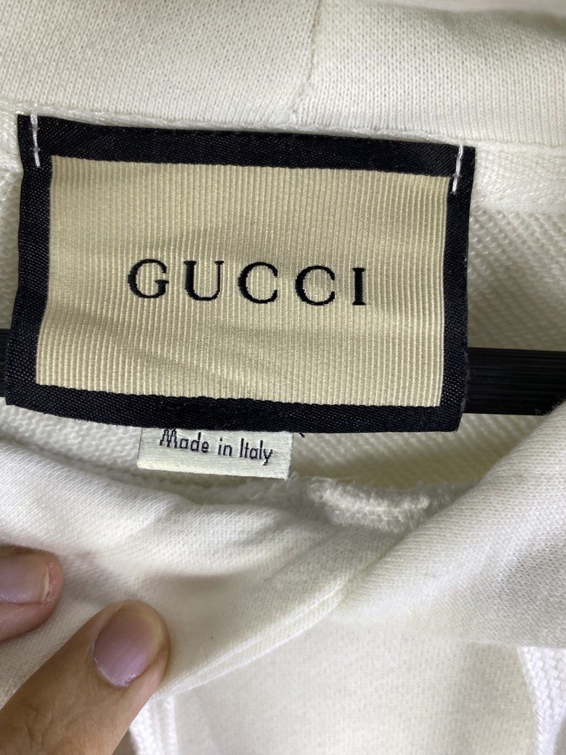 Gucci White Interlocking G Hoodie XL (Category: Coats, Jackets and Outerwear) located in Manila. Submitted by declutterpromax (Listing ID 1466019134, Image 2). Description: - Authentic Gucci hoodie in classic white - Size XL with interior brand and care tags attached - Features the iconic interlocking G logo printed on the chest - Equipped with a comfortable drawstring hood and ribbed cuffs - Premium quality, made in Italy - Condition: Brand new 