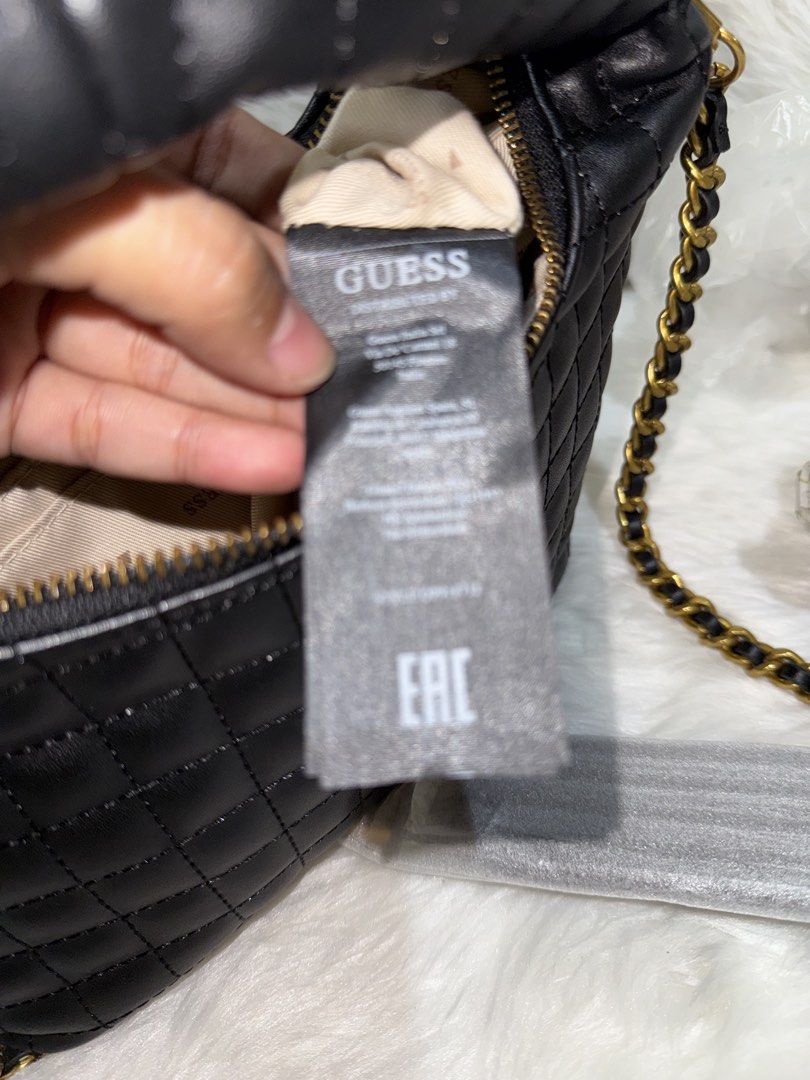 Guess Quilted Black Handbag with Chain Strap (Category: Shoulder Bags) located in Taguig. Submitted by roseanneramirez (Listing ID 1466025811, Image 3). Description: - Brand: Guess - Color: Classic black - Design: All-over quilted pattern with gold-tone hardware - Straps: Chain shoulder strap and quilted top handle - Closure: Top zip with branded pull - Condition: Brand new with original hang tag attached - Packaging: Chain strap components still