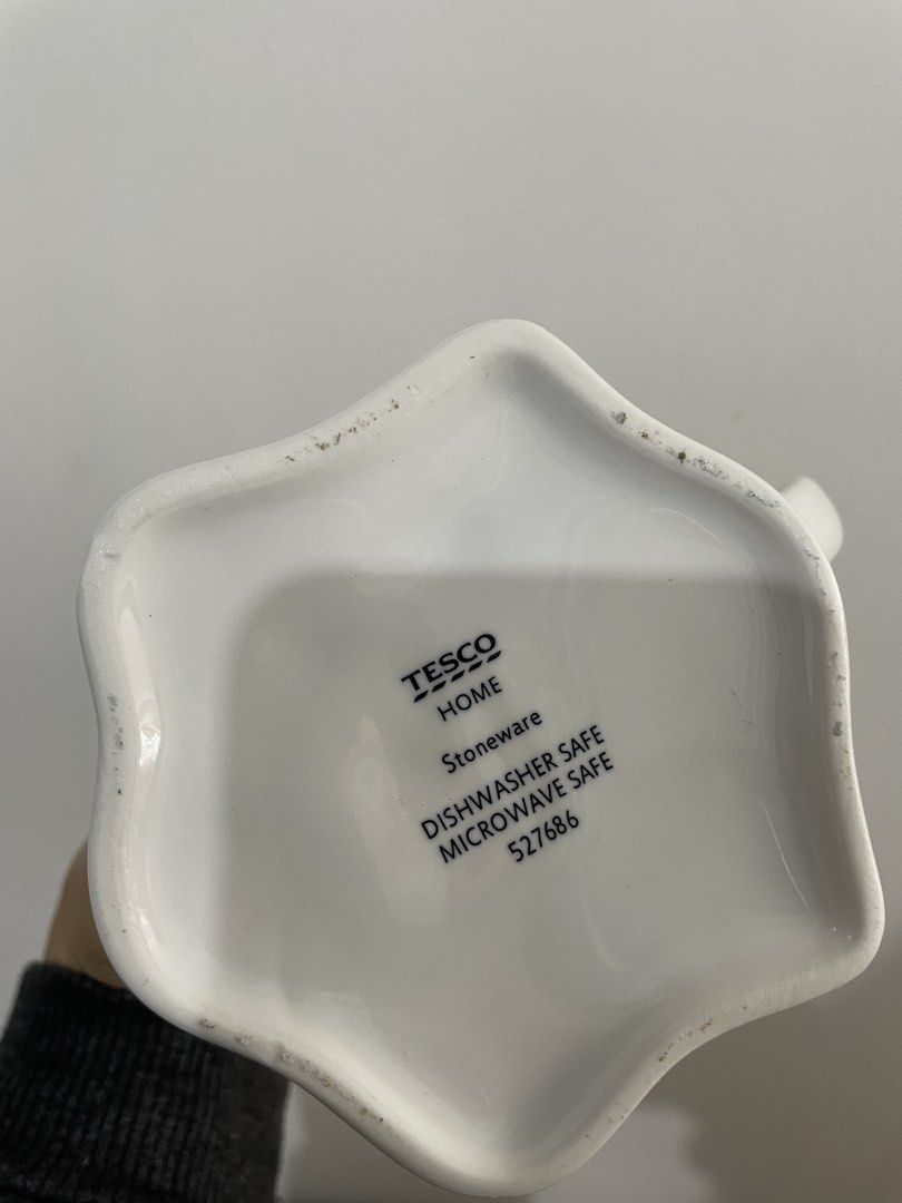 Halloween Ceramic Microwave-Safe Ghost Mug (Category: Coffee & Tea Tableware) located in Baguio. Submitted by the_general_store (Listing ID 1466100526, Image 3). Description: - Authentic Tesco Home ghost mug - Material: Sturdy white ceramic with black painted eyes - Design: Fun wavy bottom edge shaped like a bedsheet with a comfortable side handle - Care: Microwave and dishwasher safe (printed on base) - Perfect seasonal piece for your favorite c