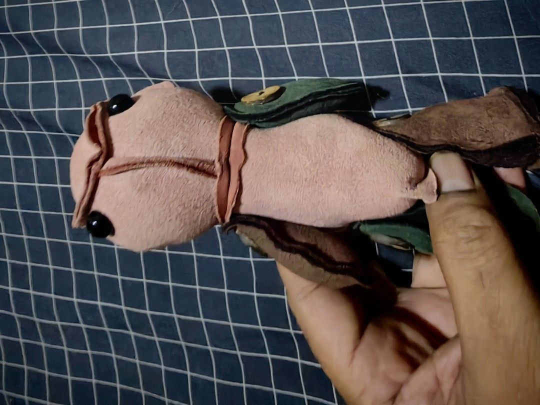 Handmade fabric creature doll plush toy (Category: Plushies & Soft Toys) located in Davao. Submitted by thefrugalshop (Listing ID 1466087474, Image 1). Description: - Handcrafted unique fabric creature doll - Soft pink body with charming black button eyes - Stylish green felt jacket accented with a yellow button - Adorable brown textured footwear - Perfect one-of-a-kind gift or collectible piece.