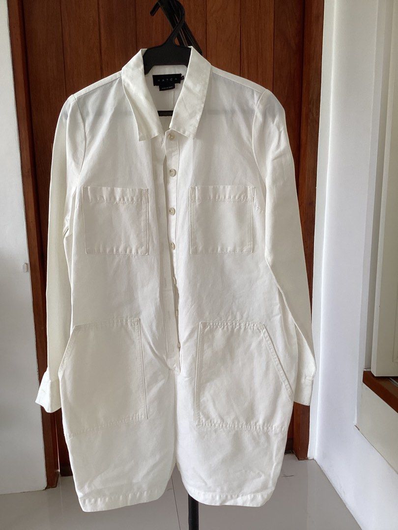 Hatch White Utility Jumpsuit Size 2 (Category: Jumpsuits) located in Bacoor. Submitted by cts217 (Listing ID 1465992257, Image 1). Description: - Brand: Hatch - Size: 2 - Color: White - Material/Origin: Made in China - Design: Button-down front closure with pointed collar and long sleeves - Features: Multiple utility pockets on the chest, front waist, and back - Fit: Straight fit through the body - Condition: Clean fabric throughout, ready to wea