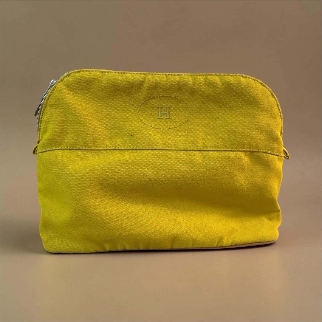 Hermès Yellow Canvas Flat Pouch (Category: Purses & Pouches) located in Manila. Submitted by attypreciousyzncpa (Listing ID 1466150162, Image 1). Description: - Authentic Hermès canvas makeup pouch in a vibrant bright yellow - Iconic embroidered oval 'H' logo on the front - Secure top zip closure with sleek silver hardware - Spacious interior ideal for cosmetics, daily essentials, or travel must-haves - Durable and sturdy fabric construction - Co