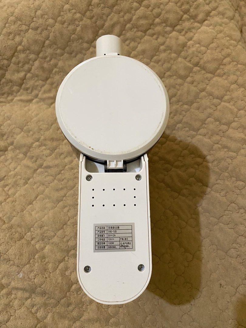 HK-V8 Cordless Handheld Vacuum Cleaner (Category: Vacuum Cleaner & Housekeeping) located in Baguio. Submitted by thrift_bonita (Listing ID 1466034630, Image 3). Description: HK-V8 model wireless vacuum cleaner. White and grey body with transparent dark dust cup. 100W rated power, 12V working voltage, 880ml dust capacity. Compact size, easy to grab handle with power button on top. Sticker label on bottom lists specs clearly. Used condition with so