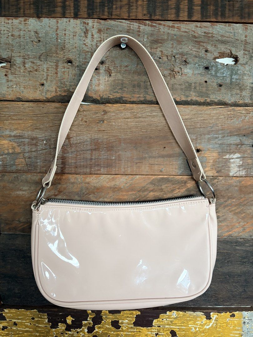 H&M Divided Pink Patent Shoulder Bag (Category: Shoulder Bags) located in Quezon City. Submitted by makingroomfinds (Listing ID 1466067459, Image 1). Description: - Brand: H&M Divided - Style: Shoulder bag - Color/Material: Pale pink patent - Hardware: Silver-toned with metal ring strap attachments - Closure: Top zipper - Interior: Matching pink fabric lining - Condition: Brand new with original tags.
