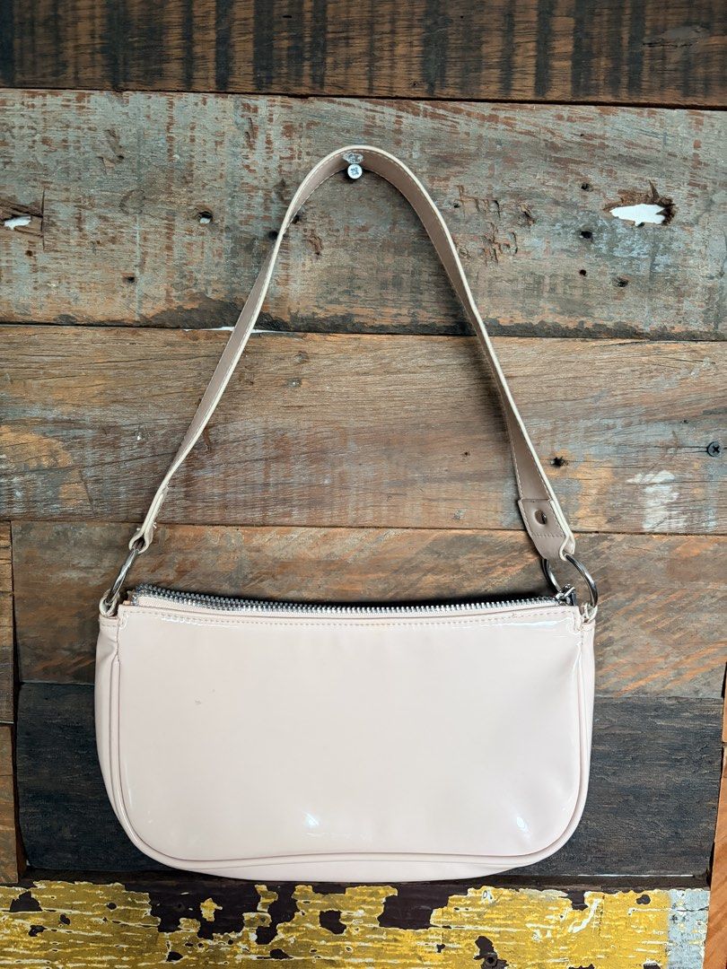 H&M Divided Pink Patent Shoulder Bag (Category: Shoulder Bags) located in Quezon City. Submitted by makingroomfinds (Listing ID 1466067459, Image 2). Description: - Brand: H&M Divided - Style: Shoulder bag - Color/Material: Pale pink patent - Hardware: Silver-toned with metal ring strap attachments - Closure: Top zipper - Interior: Matching pink fabric lining - Condition: Brand new with original tags.