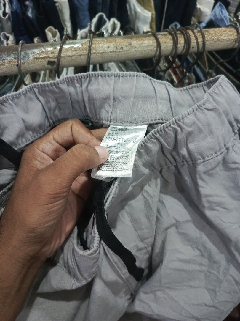 H&M Slim Fit Grey Cargo Pants Size M (Category: Trousers) located in City of Isabela. Submitted by warmbird.d06e6f (Listing ID 1466095315, Image 3). Description: - Brand/Model: H&M Cargo Pants - Fit: Slim fit - Size: Medium (EUR M) - Waistband: Elastic with black adjustable drawstring - Pockets: Secure side zippered pockets - Details: Trendy coordinate text print near the lower leg hem - Condition: Excellent.