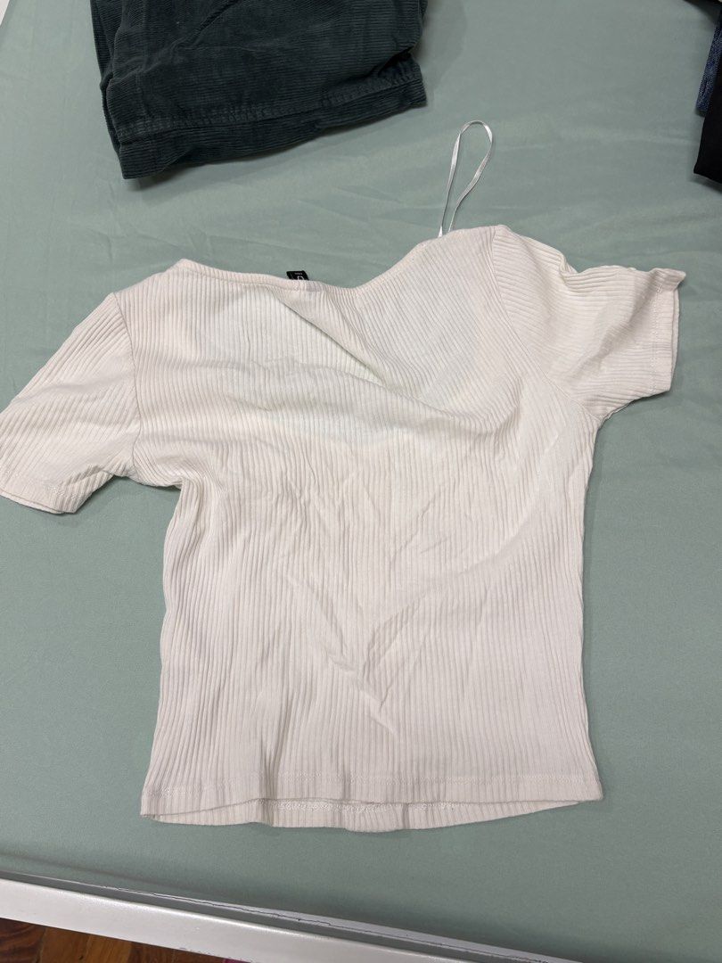 H&M White Ribbed Button-Down Short Sleeve Top (Category: Shirts) located in San Juan City. Submitted by moon.riverandme (Listing ID 1466112874, Image 3). Description: - Brand: H&M - Color: Clean white - Style: Short sleeve cropped top with wide scoop neckline - Details: Ribbed fabric all over with 5 brown front buttons - Fit: Easy to match with high-waisted denim or skirts - Perfect for casual wear!.