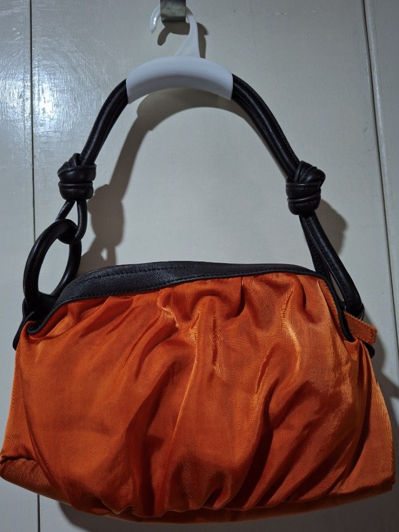 Hobo Sequoia Kili Bag (Category: Tote Bags) located in Caloocan City. Submitted by zzzzzaaay (Listing ID 1466000897, Image 1). Description: - Vibrant orange ruched shoulder bag with a stylish textured fabric body - Dark brown leather handles featuring trendy knotted details and a circular ring connector (little scratch, dm for pic) - Secure top zipper closure to keep your belongings safe - Practical size with a deep colour that easily stands out 