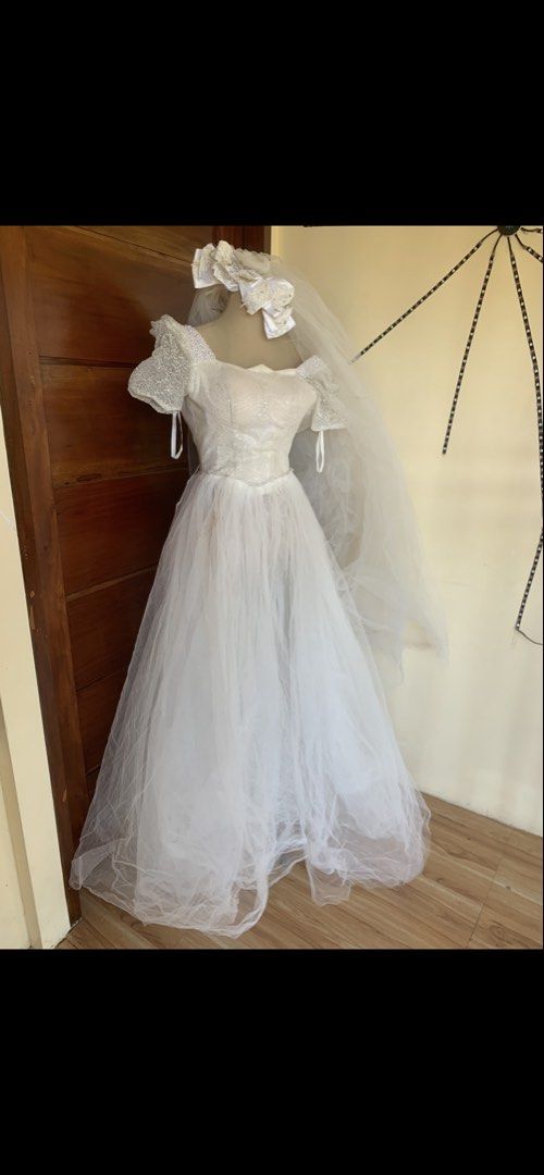 Holloween costume (Category: Evening dresses & gowns) located in Manila. Submitted by spaceshop12345 (Listing ID 1466155189, Image 1). Description: - Style: Traditional princess wedding dress / Full length gown - Bodice: Sparkly design with a pearl-trimmed square neckline - Sleeves: Puff sleeves with delicate lace overlay - Skirt: Full, voluminous tulle skirt - Extras: Includes matching veil with a large decorative pearl and lace bow headpiece - 