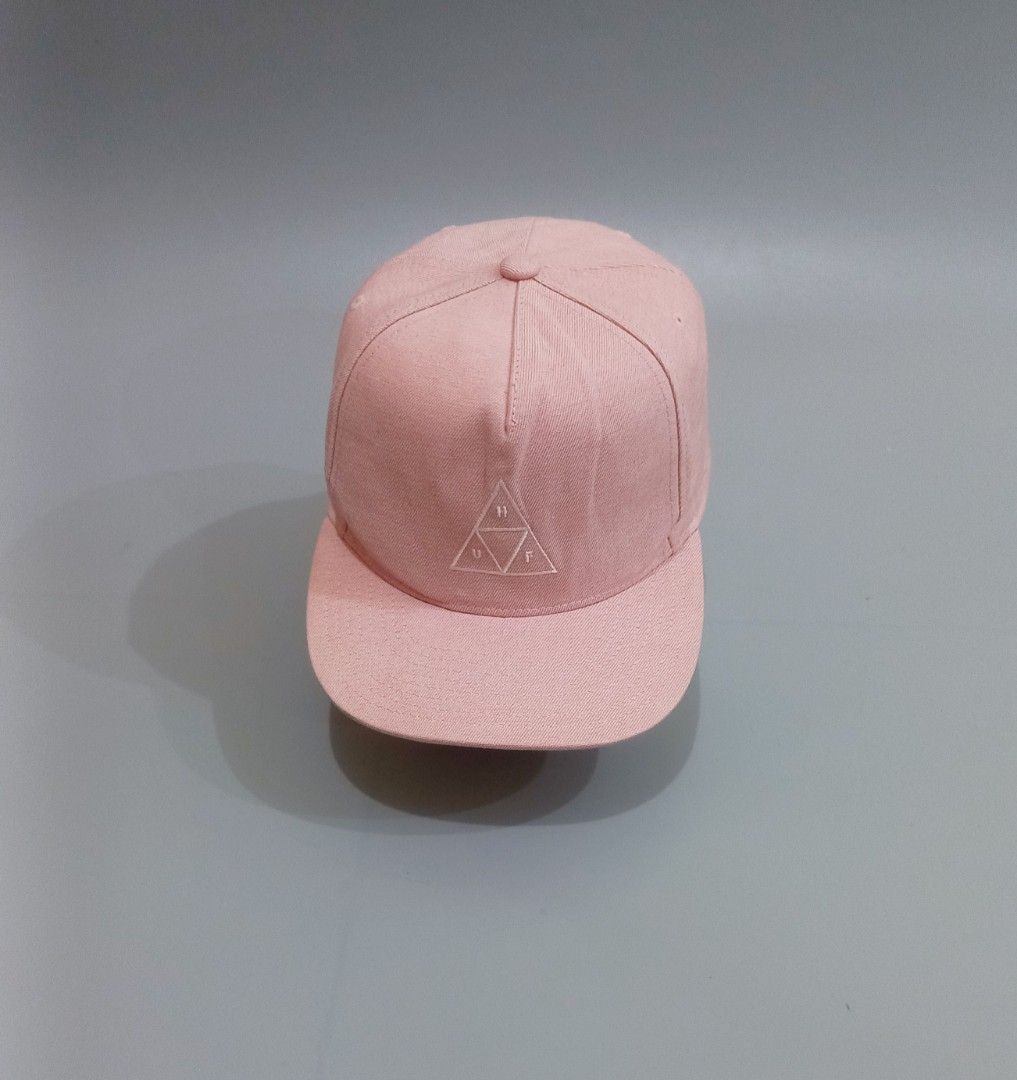 HUF Pink Snapback Hat (Category: Caps & Hats) located in Cebu City. Submitted by MrLiks_123 (Listing ID 1466107225, Image 2). Description: - Brand: HUF - Style: Snapback cap - Color: Pink with white embroidered triangle logo - Closure: Adjustable black plastic strap - Material: 60% cotton, 40% polyester - Origin: Made in Vietnam - Condition: / Excellent.