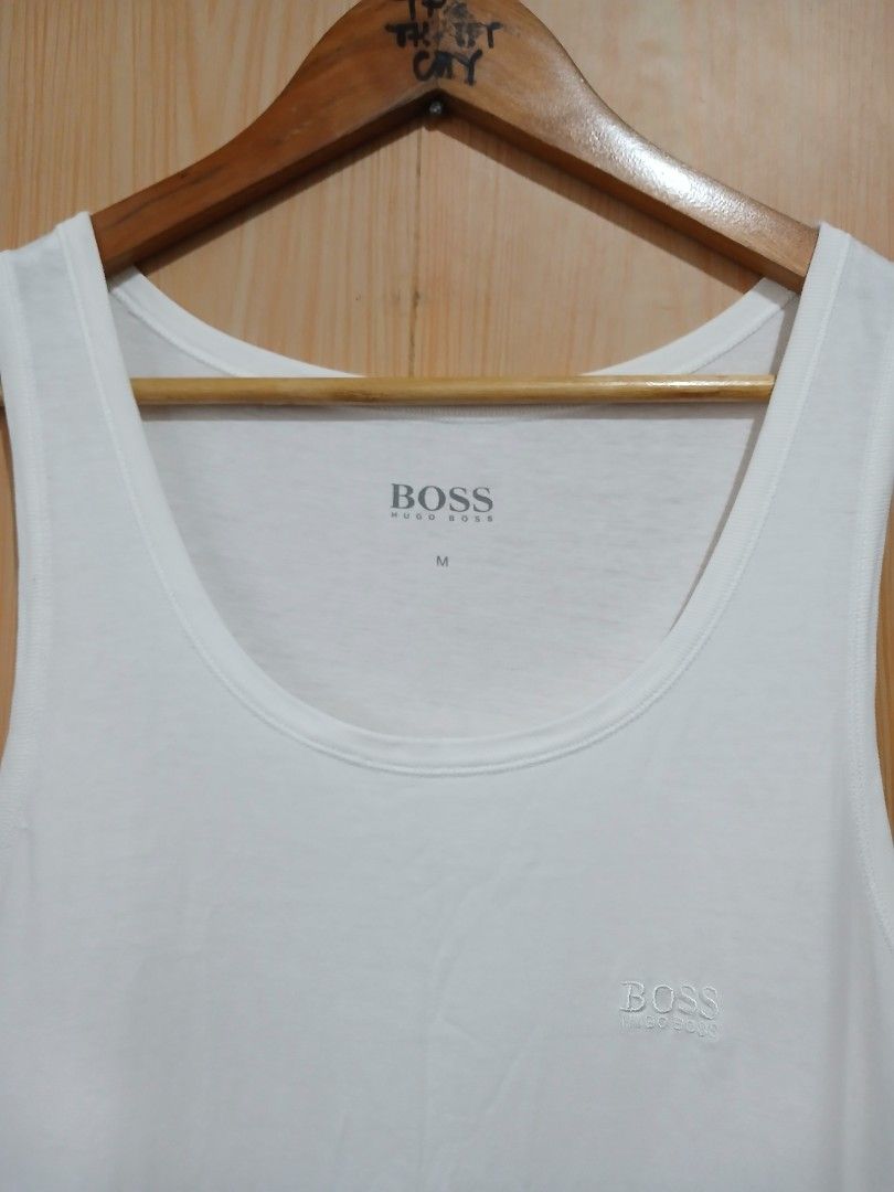 Hugo Boss White Tank Top Size M (Category: Activewear) located in Daraga. Submitted by thethriftcity2024 (Listing ID 1466082407, Image 3). Description: - Brand: Hugo Boss - Size: Medium - Color: Classic White - Material: Soft and comfortable cotton blend - Design: Embroidered chest logo, scoop neckline, and sleeveless cut - Condition: Brand new with tagged inner collar branding - Perfect for casual wear or layering Excellent 18*28 9.5/10 color ra