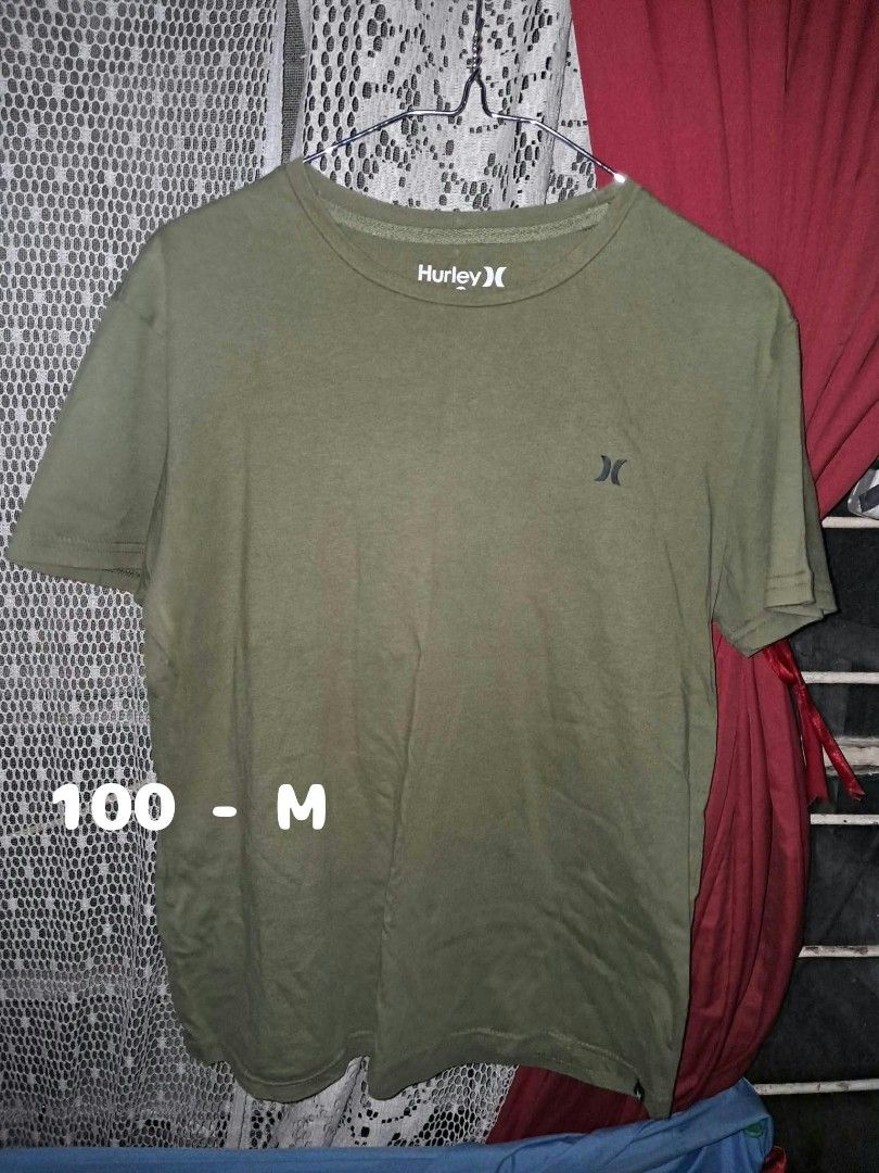 Hurley Olive Green T-Shirt Size M (Category: Tshirts & Polo Shirts ) located in Makati City. Submitted by j.angelxa (Listing ID 1465980621, Image 1). Description: - Brand: Hurley - Color: Olive green - Size: M (tagless inside collar) - Fit: Standard fit with short sleeves - Design: Small printed logo on left chest - Material: Soft, comfortable cotton for daily wear - Condition: Clean neckline, hem, and cuffs in solid condition.