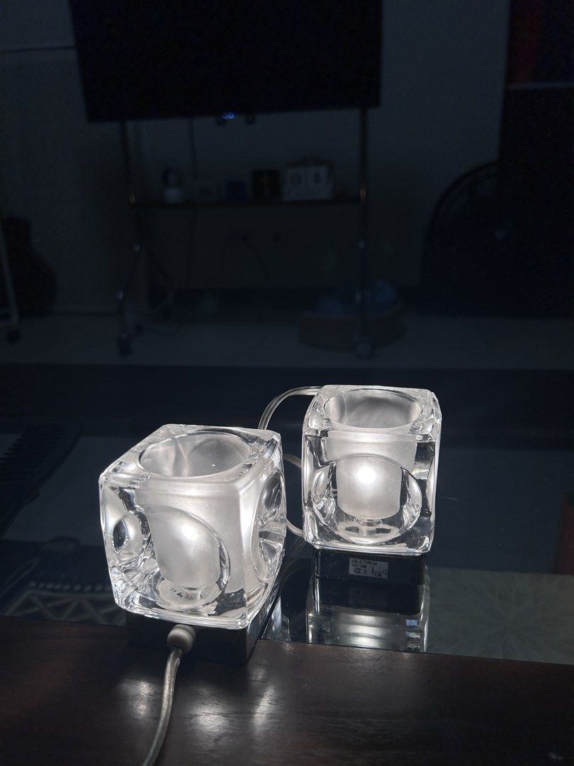 Ice Cube Table Lamps Pair (Category: Lighting) located in Del Monte. Submitted by roseanncub90895 (Listing ID 1466066392, Image 1). Description: - Set of 2 modern heavy glass cube table lamps - Frosted inner glass cylinder with chrome base - Uses 12V 10W G4 bulbs (tested and working) - Clear transparent power cords - Reflects light beautifully on any surface - Selling as a set -Warm light in actual.