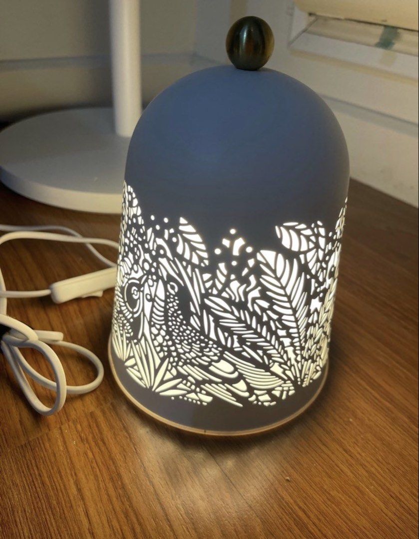 IKEA White cut-out decorative accent table lamp with bird pattern (Category: Lighting) located in Makati City. Submitted by japaneseshop (Listing ID 1466111610, Image 1). Description: - Elegant white ceramic dome lamp with intricate cut-out bird and leaf patterns - Emits a cozy, soft warm glow when turned on - Includes a white power cord with a convenient inline switch - Features a stylish small brass-tone sphere top handle - Compact size, perfec