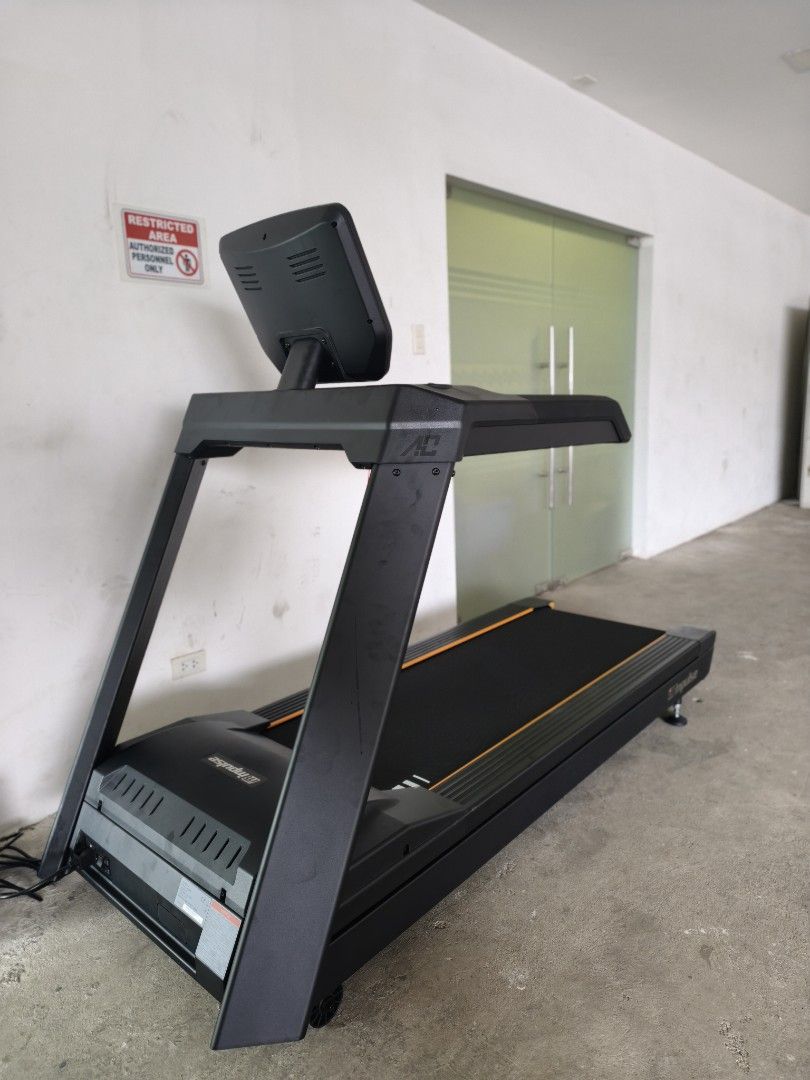 Impulse AC2990 COMMERCIAL TREADMILL (Category: Cardio & Fitness Machines) located in Caloocan City. Submitted by fitness.source.ph (Listing ID 1465995214, Image 1). Description: - Heavy-duty Impulse commercial treadmill in sleek matte black with striking orange accents - Large digital console display with multiple tracking buttons, cup holders, and red safety key tether - Solid construction featuring sturdy handrails and adjustable leveling feet 
