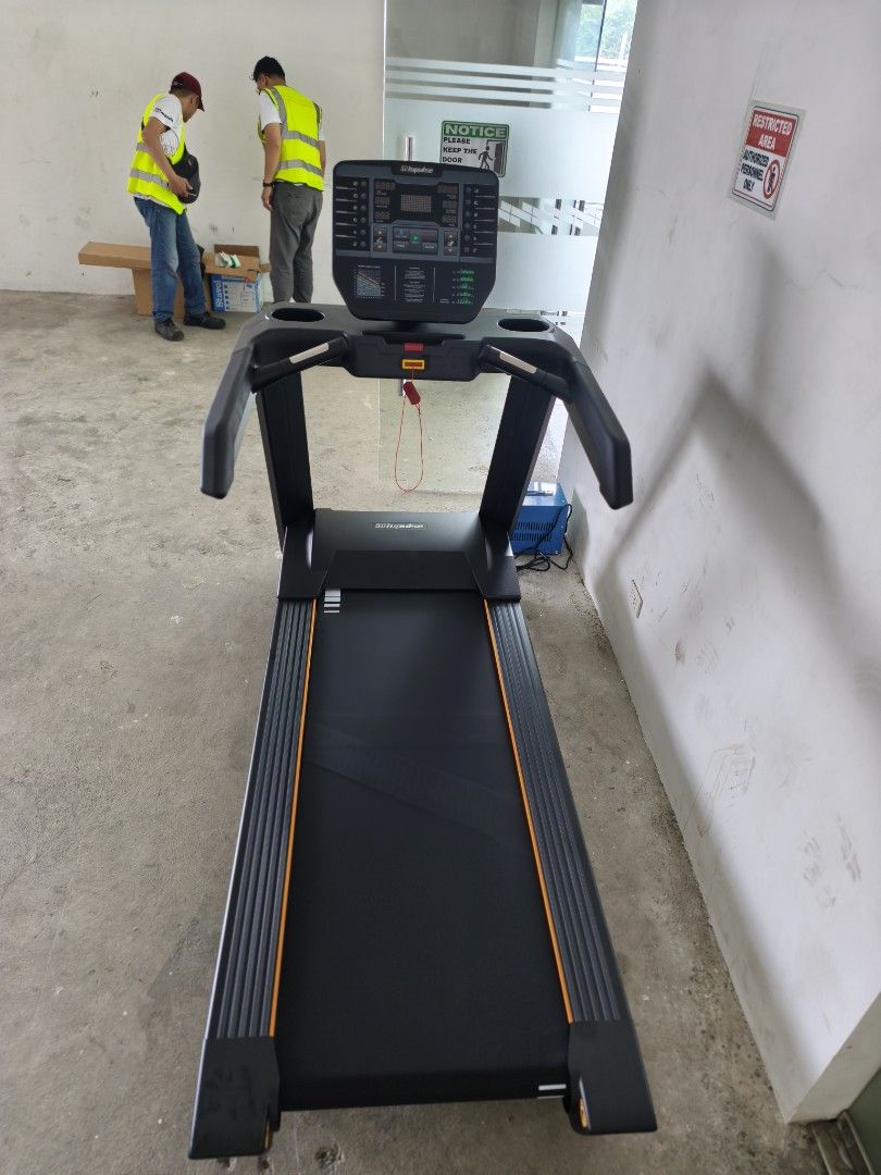 Impulse AC2990 COMMERCIAL TREADMILL (Category: Cardio & Fitness Machines) located in Caloocan City. Submitted by fitness.source.ph (Listing ID 1465995214, Image 2). Description: - Heavy-duty Impulse commercial treadmill in sleek matte black with striking orange accents - Large digital console display with multiple tracking buttons, cup holders, and red safety key tether - Solid construction featuring sturdy handrails and adjustable leveling feet 
