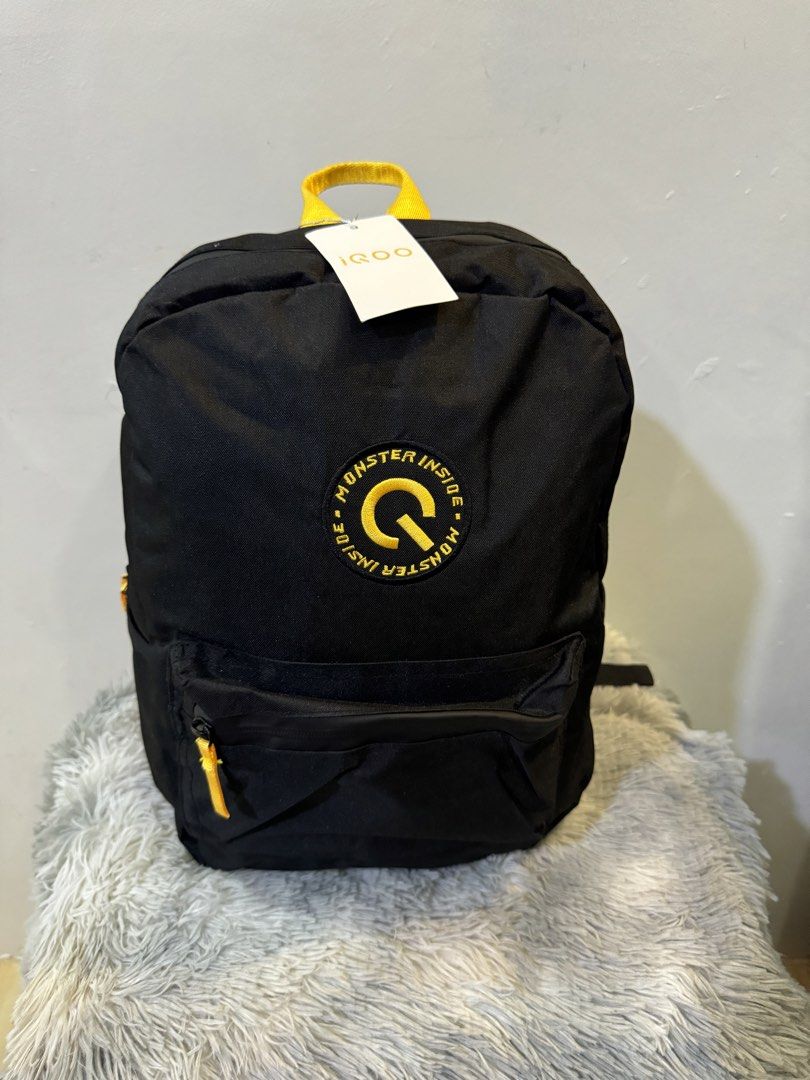 iQOO Monster Inside Black Backpack with Yellow Accents (Category: Backpacks) located in Urdaneta. Submitted by kathleenja24136 (Listing ID 1465958147, Image 1). Description: - Authentic black iQOO backpack with vibrant yellow accents - Features a cool round 'Monster Inside' logo patch on the front - Secure main compartment zip closure and front zippered pocket - Convenient side slip pockets for water bottles or essentials - Comfortable top grab h