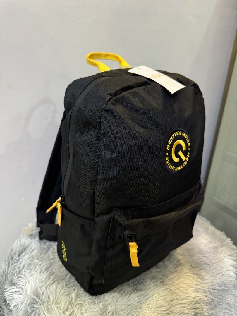 iQOO Monster Inside Black Backpack with Yellow Accents (Category: Backpacks) located in Urdaneta. Submitted by kathleenja24136 (Listing ID 1465958147, Image 2). Description: - Authentic black iQOO backpack with vibrant yellow accents - Features a cool round 'Monster Inside' logo patch on the front - Secure main compartment zip closure and front zippered pocket - Convenient side slip pockets for water bottles or essentials - Comfortable top grab h