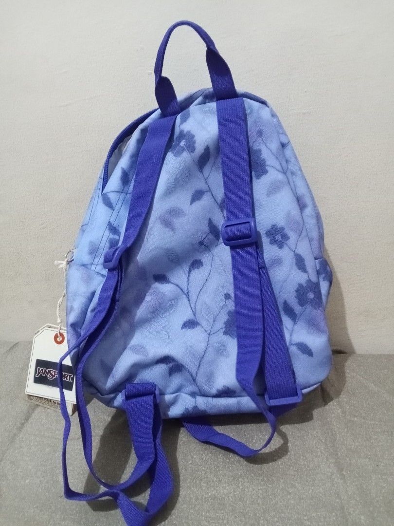 JanSport Half Pint Mini Backpack Lines & Vines (Category: Backpacks) located in Manila. Submitted by nics_parker (Listing ID 1466019378, Image 3). Description: - Brand: JanSport Half Pint Mini Backpack - Print/Color: Lines and Vines (Light blue with dark blue floral/botanical pattern) - Straps: Adjustable purple shoulder straps with top haul loop - Compartments: Main compartment and handy front zippered pocket - Capacity: 10 liters - Condition: B