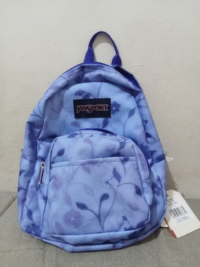 JanSport Half Pint Mini Backpack Lines & Vines (Category: Backpacks) located in Manila. Submitted by nics_parker (Listing ID 1466019378, Image 2). Description: - Brand: JanSport Half Pint Mini Backpack - Print/Color: Lines and Vines (Light blue with dark blue floral/botanical pattern) - Straps: Adjustable purple shoulder straps with top haul loop - Compartments: Main compartment and handy front zippered pocket - Capacity: 10 liters - Condition: B