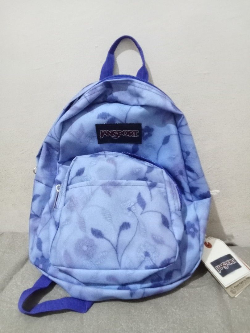JanSport Half Pint Mini Backpack Lines & Vines (Category: Backpacks) located in Manila. Submitted by nics_parker (Listing ID 1466019378, Image 1). Description: - Brand: JanSport Half Pint Mini Backpack - Print/Color: Lines and Vines (Light blue with dark blue floral/botanical pattern) - Straps: Adjustable purple shoulder straps with top haul loop - Compartments: Main compartment and handy front zippered pocket - Capacity: 10 liters - Condition: B