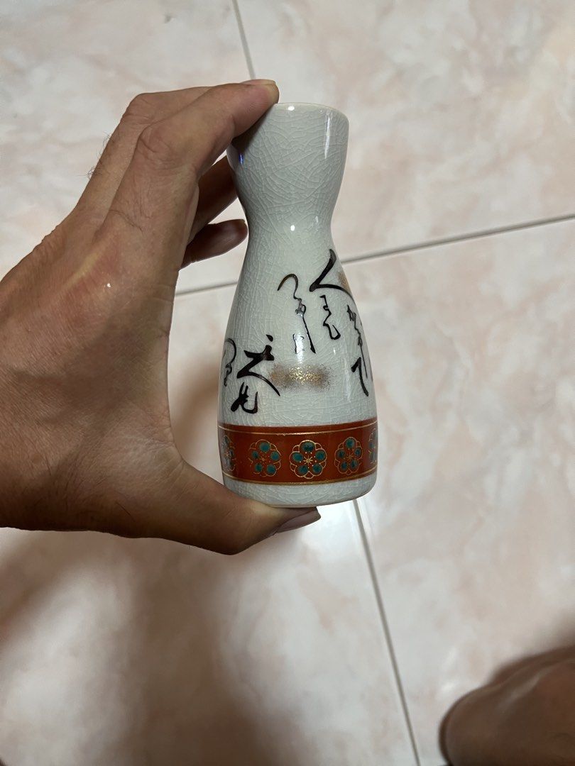 Japan kutani sake set (Category: Other Kitchenware & Tableware) located in Manila. Submitted by rlab_japan_thrift (Listing ID 1466056586, Image 2). Description: Japanese Vintage Kutani Crackle Glaze Sake Set (7 Pieces) 🍶✨ An authentic Japanese ceramic sake set featuring a fine crackle glaze finish (Kanni), hand-painted calligraphy, and gold-accented floral borders around the base. Comes complete in its original satin-lined gift presentation box!