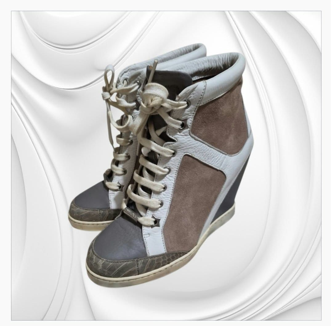 Jimmy Choo Wedge Sneakers (Category: Wedges) located in Paranaque City. Submitted by calm_youngstore7 (Listing ID 1466148316, Image 3). Description: Jimmy Choo "Panama" wedge sneaker boots. This design blends elements of a high-top sneaker with an integrated wedge heel. • Materials & Construction: Crafted from a mix of textured taupe suede panels and white smooth leather trimming. • Distinct Details: Feature an embossed snake-print texture along 