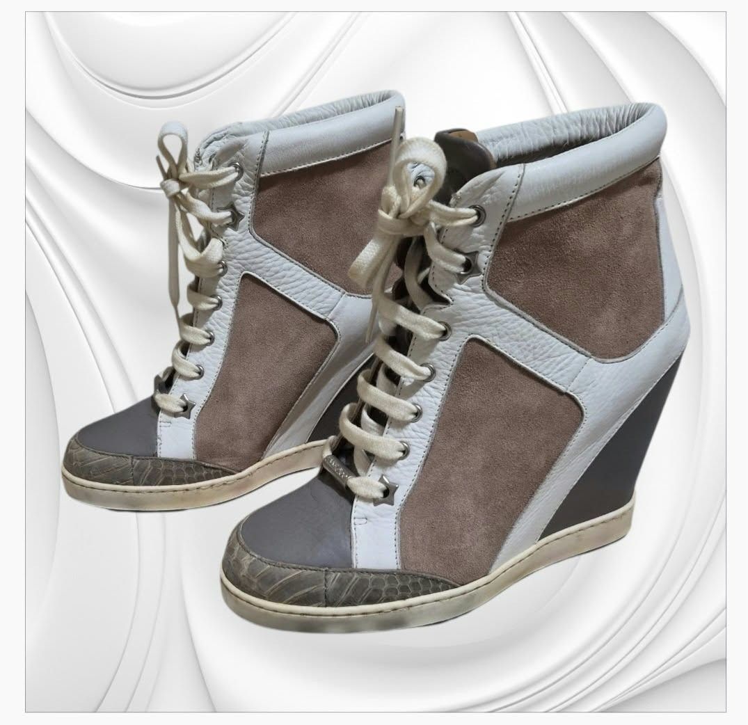 Jimmy Choo Wedge Sneakers (Category: Wedges) located in Paranaque City. Submitted by calm_youngstore7 (Listing ID 1466148316, Image 1). Description: Jimmy Choo "Panama" wedge sneaker boots. This design blends elements of a high-top sneaker with an integrated wedge heel. • Materials & Construction: Crafted from a mix of textured taupe suede panels and white smooth leather trimming. • Distinct Details: Feature an embossed snake-print texture along 