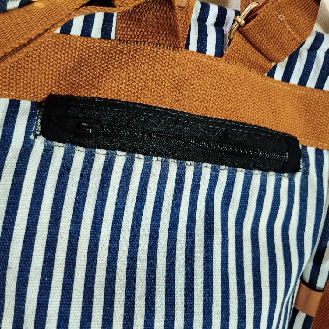 JM Striped Canvas Backpack (Category: Backpacks) located in Quezon City. Submitted by vialou03 (Listing ID 1466002791, Image 3). Description: DETAILS: • JM Brand • 12.5 x 4 x 9 (IN) • Bought from Carousell • No when worn • Newly washed • Zipper was added to the back compartment (It was just open when I bought it) Issues • With signs of use but not noticeable • The back zipper was hand-sewn, it is imperfect aesthetically. MOP: Gcash/Maya only MOD:
