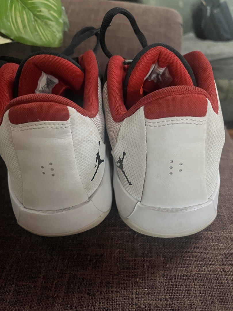 Jordan (Category: Sneakers) located in Quezon City. Submitted by retann (Listing ID 1465955625, Image 2). Description: - Brand: Jordan - Style: Low-top basketball shoes - Colorway: White, black, and red - Design Features: Mesh side panels, solid black toe box, red inner lining, and iconic Jumpman logo on the heel and sole - Traction: Grip traction patterns on the bottom - Condition: Visible wear on the soles, still fully functional.
